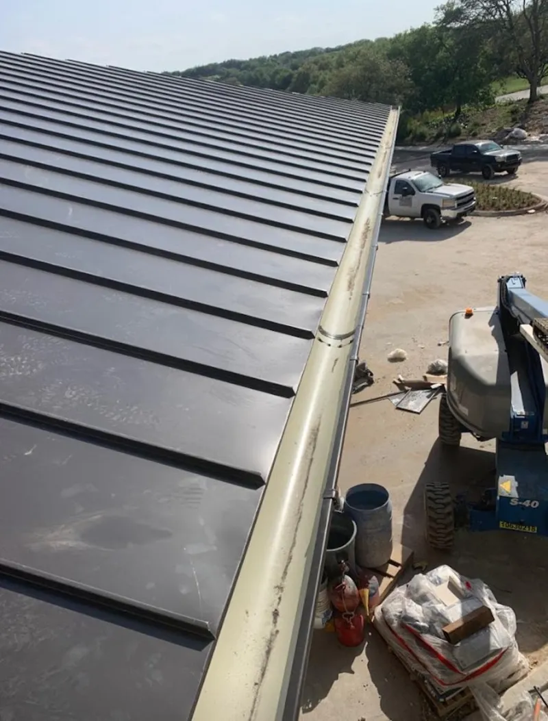 Standing seam panel and gutter detail on a metal roofing jobsite in Orange